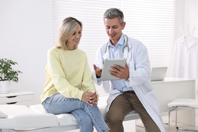 Healthcare worker with tablet and patient in hospital