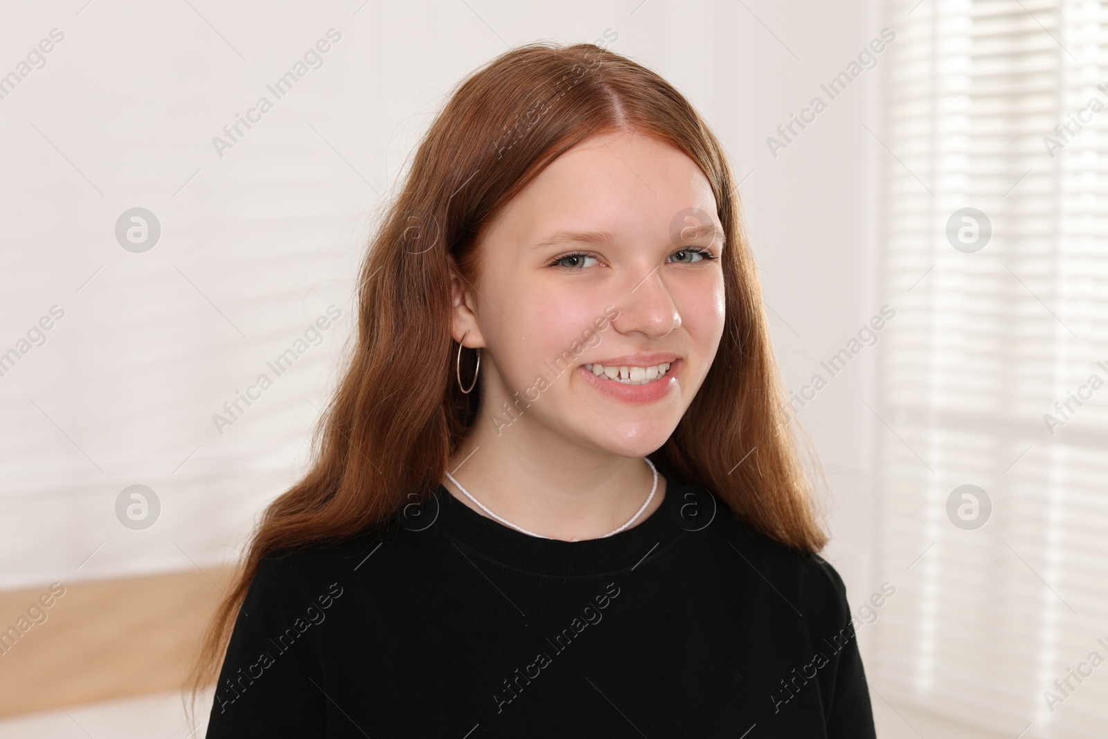 Photo of Portrait of happy teenage girl at home