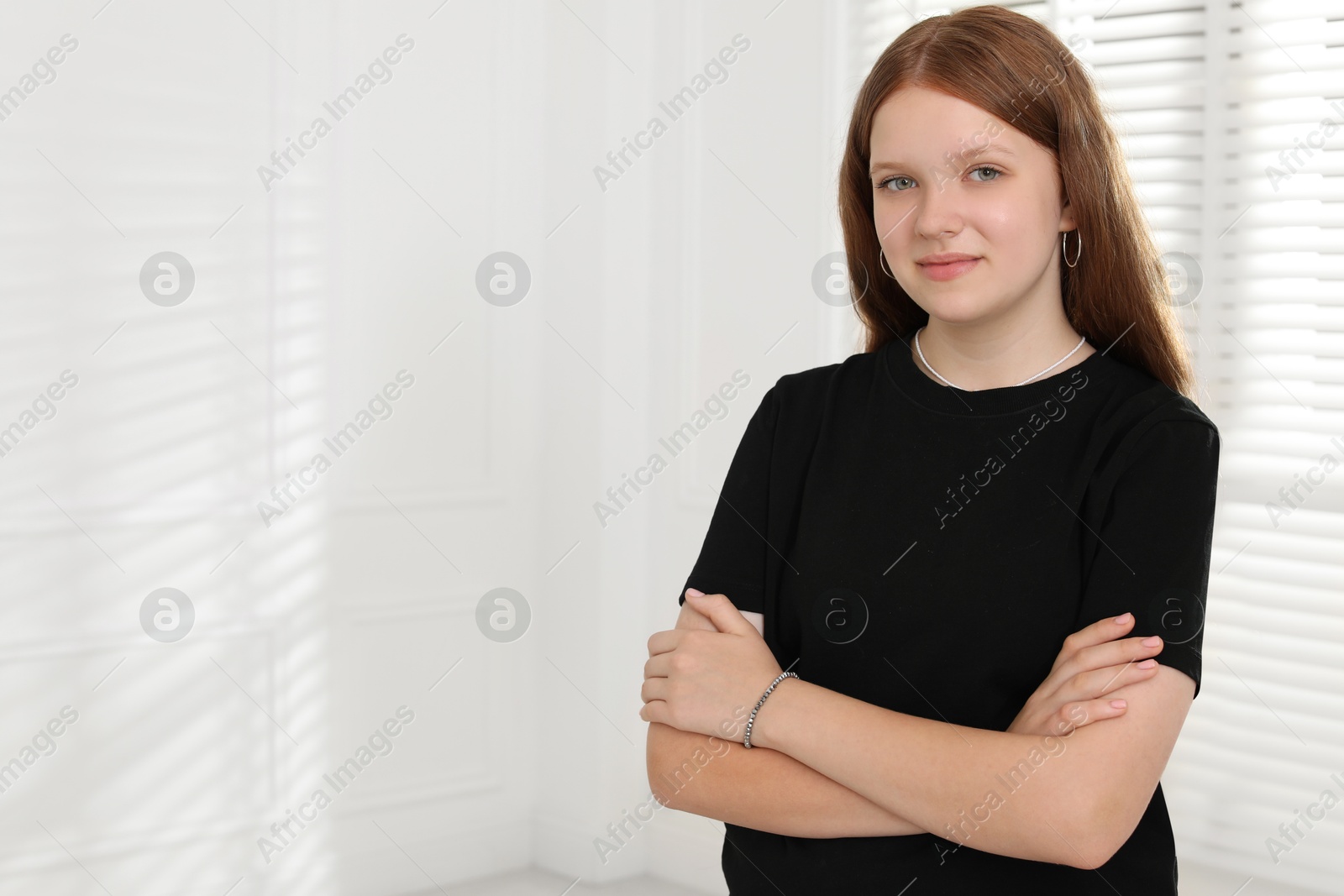 Photo of Portrait of happy teenage girl at home, space for text