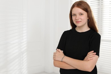 Photo of Portrait of happy teenage girl at home, space for text