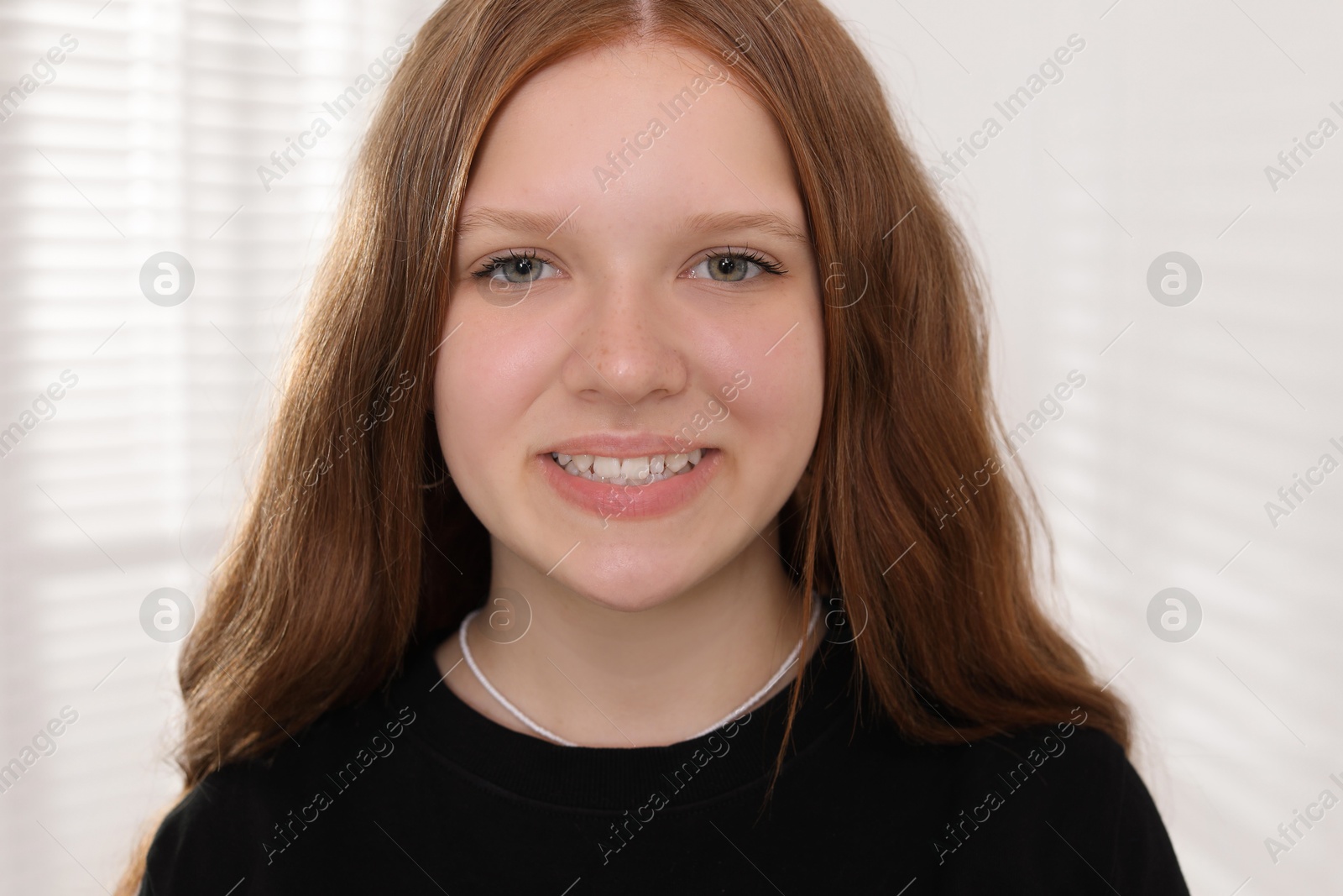 Photo of Portrait of happy teenage girl at home