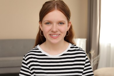 Photo of Portrait of happy teenage girl at home