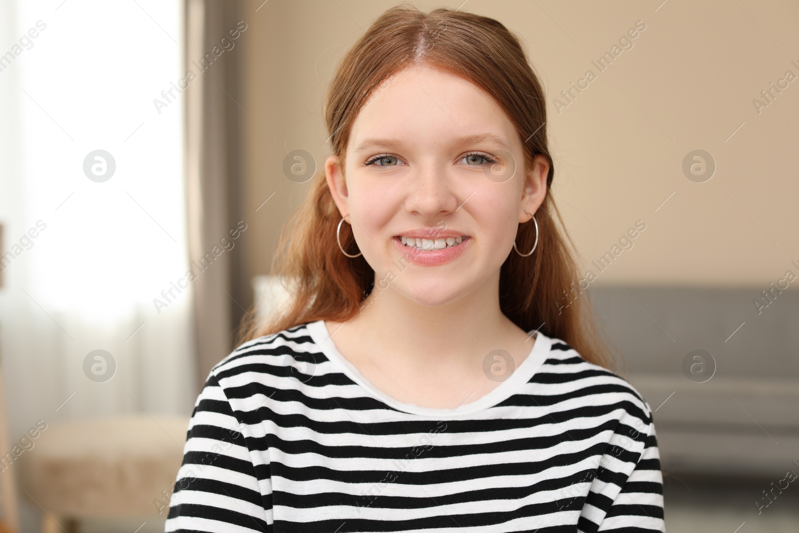 Photo of Portrait of happy teenage girl at home