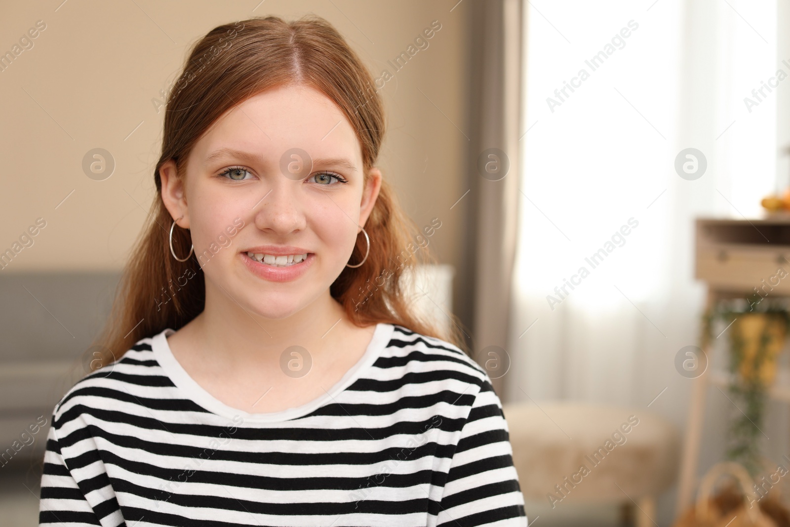 Photo of Portrait of happy teenage girl at home