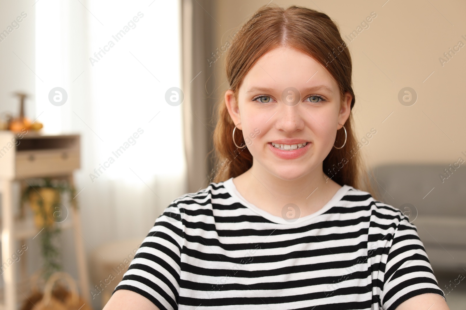 Photo of Portrait of happy teenage girl at home