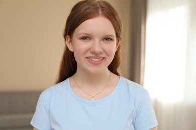 Photo of Portrait of happy teenage girl at home