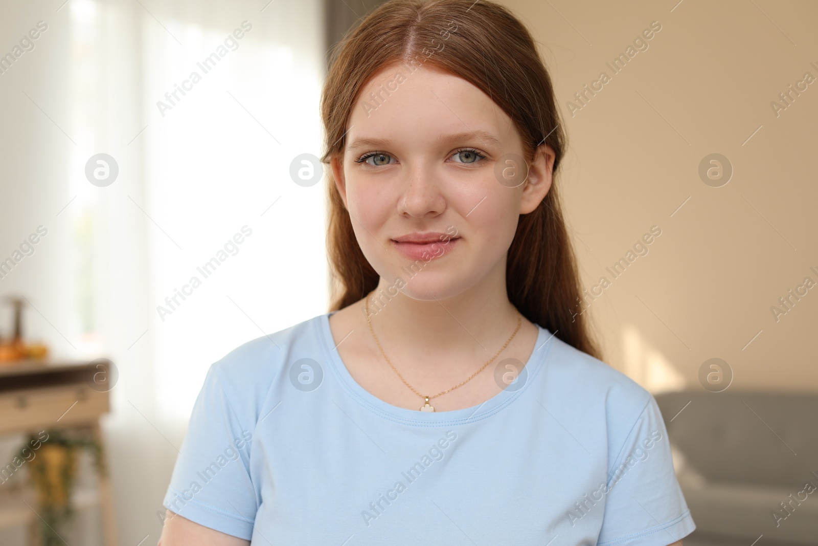 Photo of Portrait of happy teenage girl at home