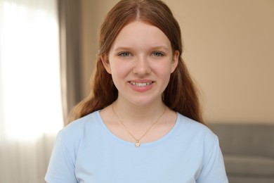 Photo of Portrait of happy teenage girl at home