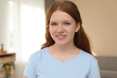 Photo of Portrait of happy teenage girl at home