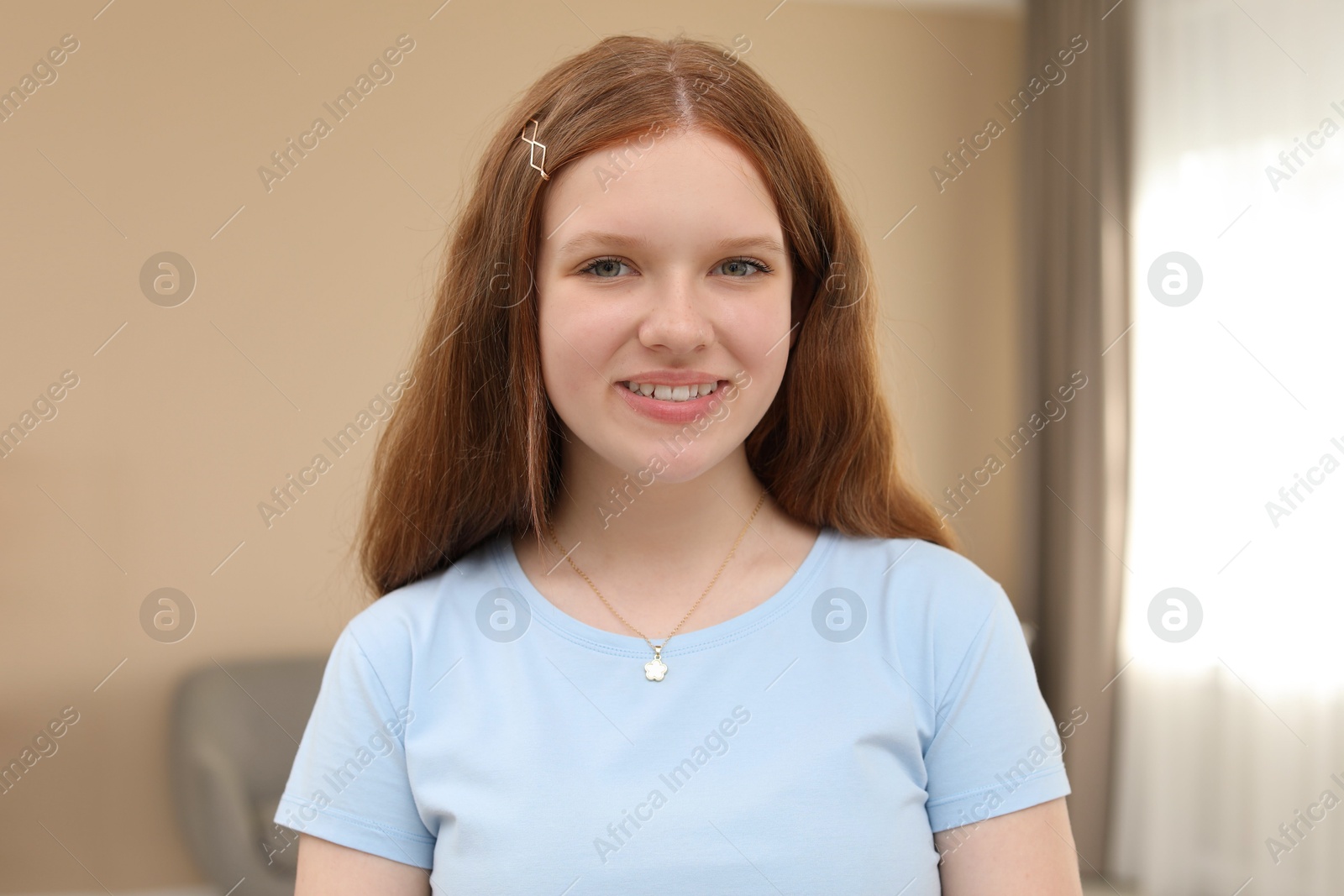 Photo of Portrait of happy teenage girl at home