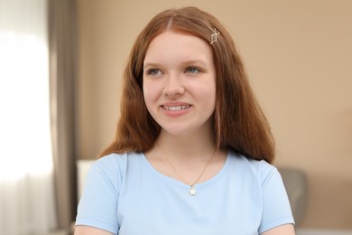 Photo of Portrait of happy teenage girl at home