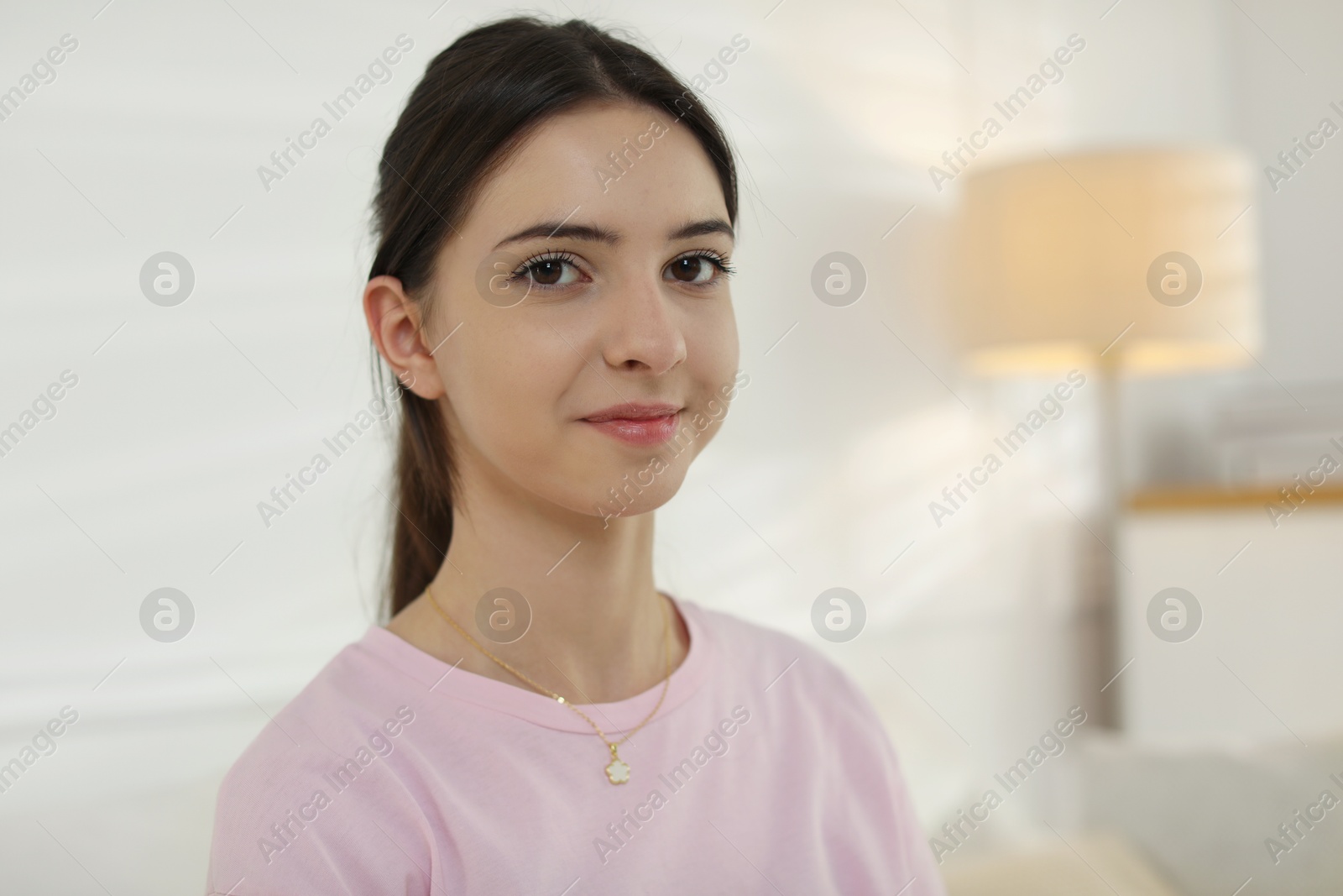 Photo of Portrait of beautiful teenage girl at home. Space for text