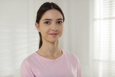 Photo of Portrait of beautiful teenage girl at home