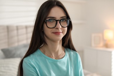 Photo of Portrait of beautiful teenage girl in glasses at home