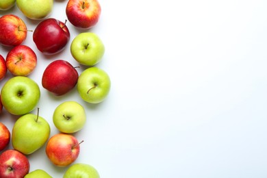 Red and green apples on white background, flat lay. Space for text