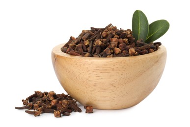 Dry clove buds and green leaves in wooden bowl on white background. Aromatic spice