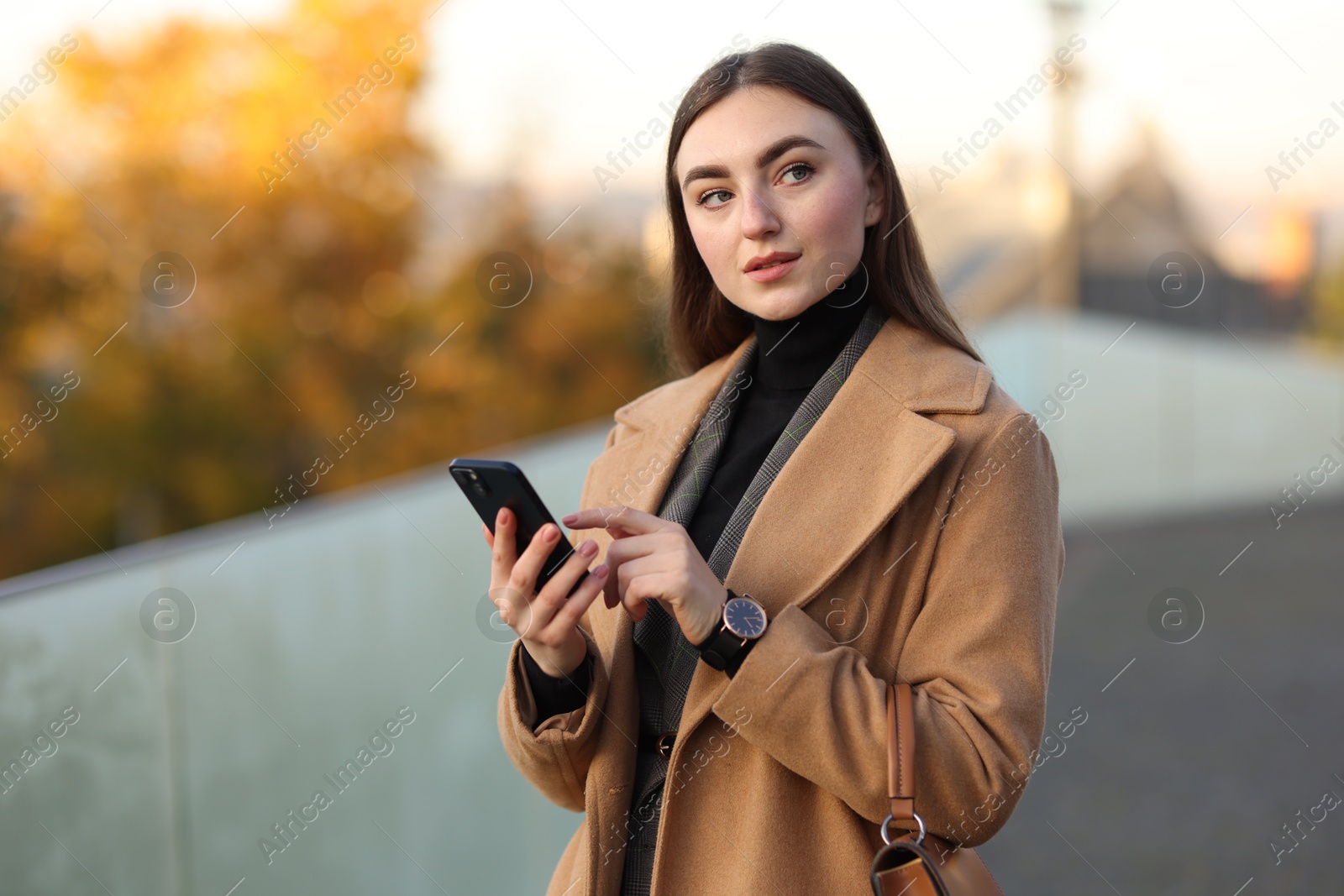 Photo of Businesswoman in stylish suit with smartphone outdoors. Space for text