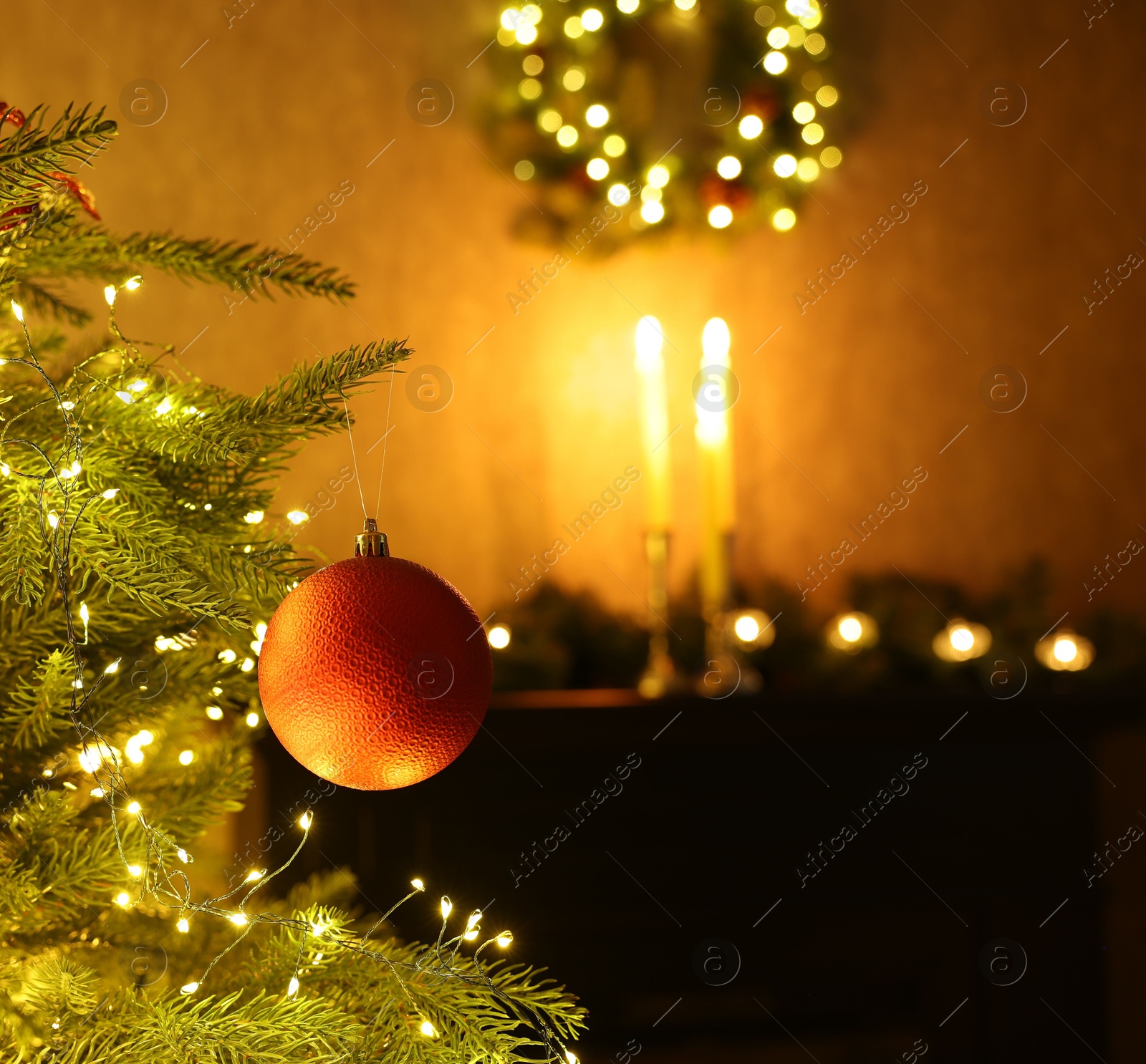 Photo of Christmas tree decorated with bauble and festive lights indoors, closeup. Space for text