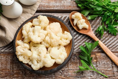 Photo of Tasty cauliflower served on wooden table, flat lay