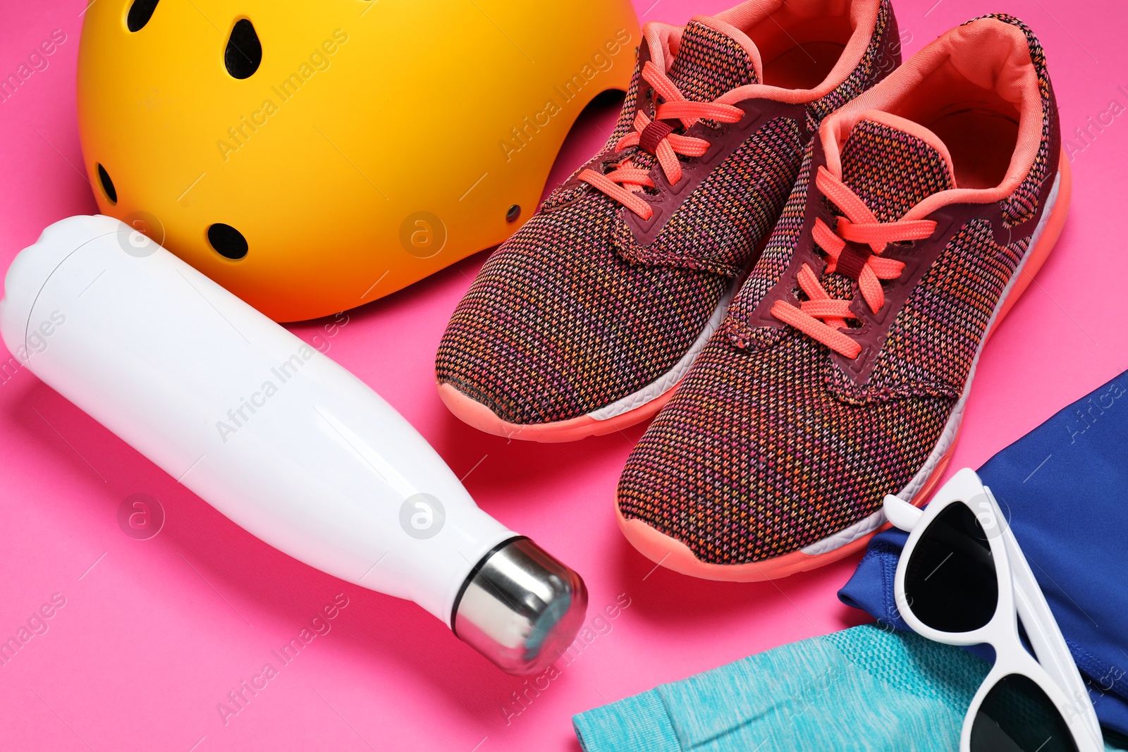 Photo of Bicycle helmet and accessories on pink background