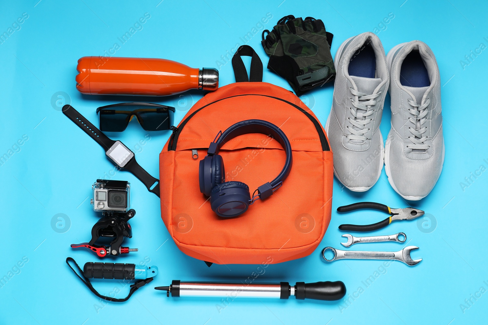 Photo of Flat lay composition with bicycle accessories on light blue background