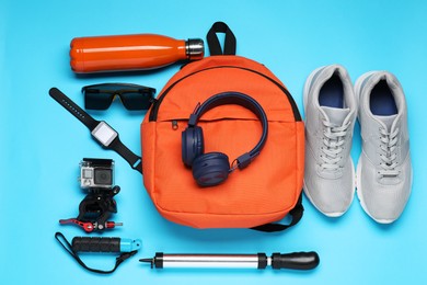 Photo of Flat lay composition with bicycle accessories on light blue background