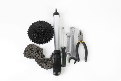 Photo of Parts of bicycle and tools on white background, above view