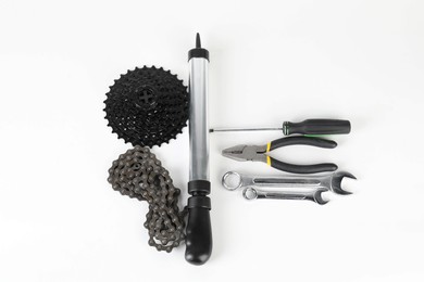 Photo of Parts of bicycle and tools on white background, above view