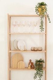 Photo of Tableware on shelving unit near light wall