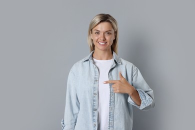 Portrait of happy winner on gray background