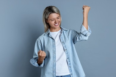 Photo of Portrait of happy winner on gray background