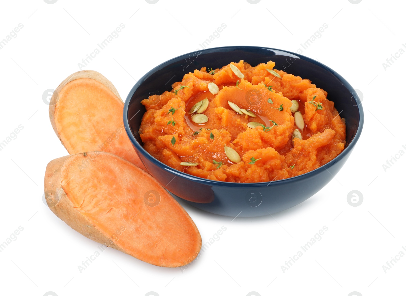 Photo of Tasty mashed sweet potato with pumpkin seeds in bowl and cut vegetables isolated on white