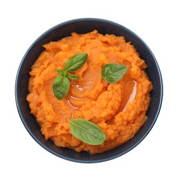 Photo of Tasty mashed sweet potato with basil in bowl isolated on white, top view