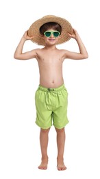 Photo of Little boy in beachwear, sunglasses and straw hat on white background