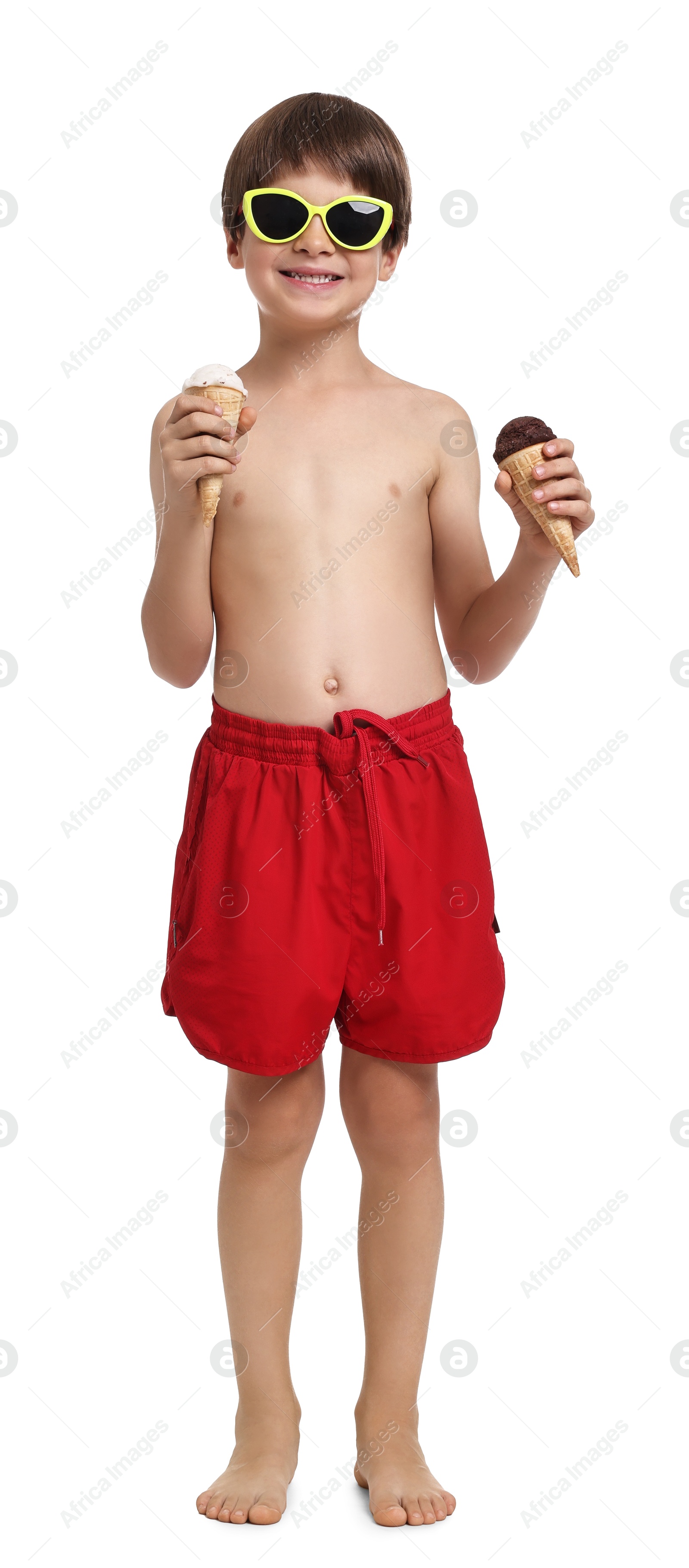 Photo of Little boy in beachwear holding ice cream on white background