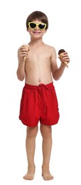 Photo of Little boy in beachwear holding ice cream on white background