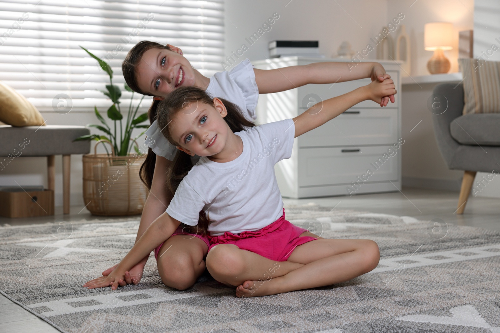 Photo of Portrait of cute little sisters at home