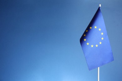 Photo of One flag of European Union on blue background. Space for text