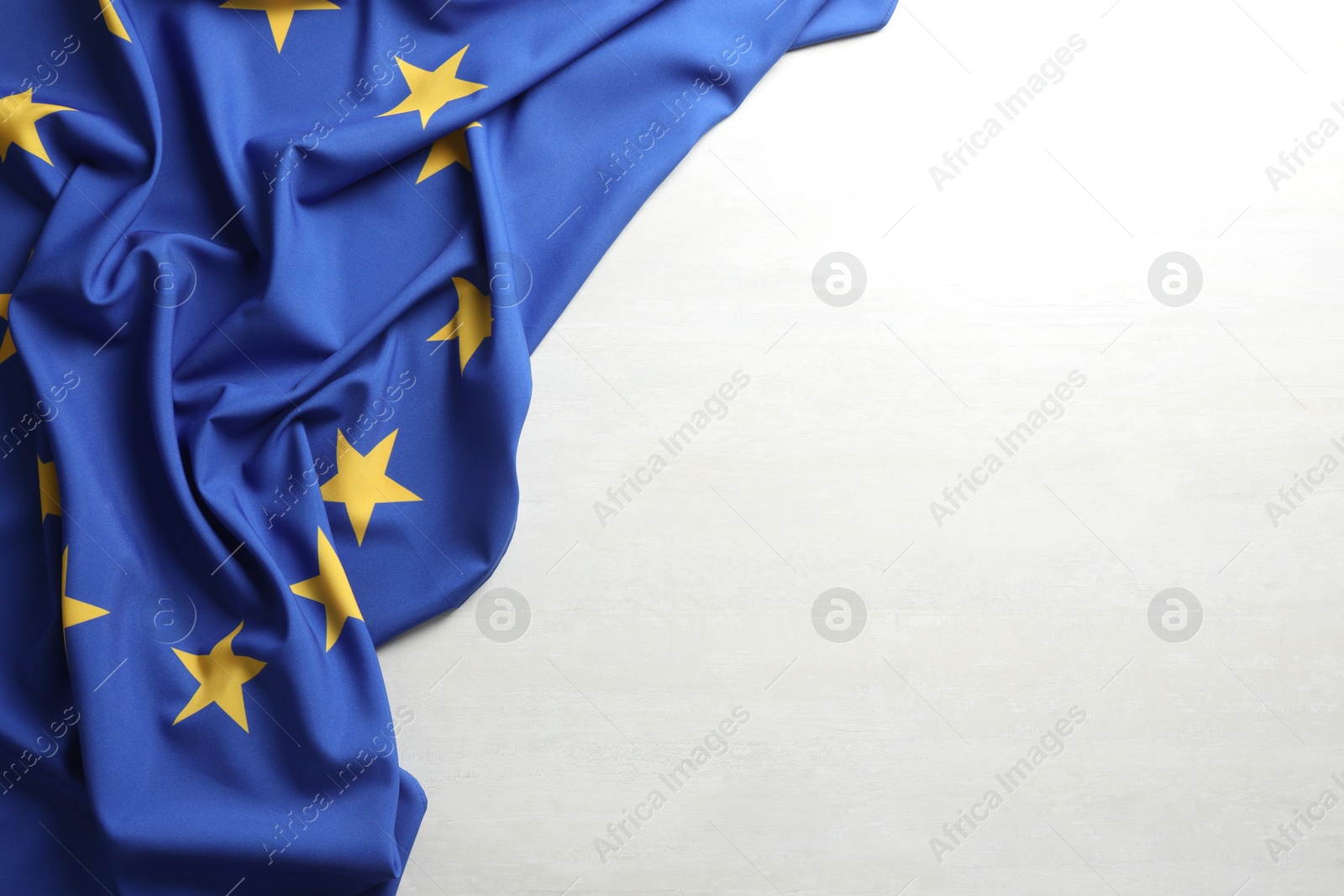 Photo of Flag of European Union on white textured background, above view. Space for text