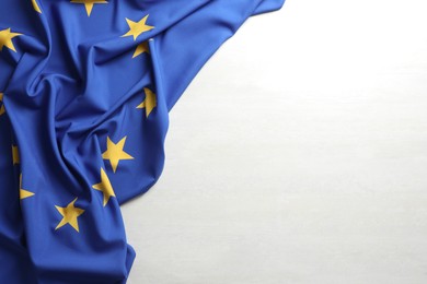 Photo of Flag of European Union on white textured background, above view. Space for text