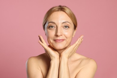 Photo of Portrait of beautiful woman with healthy skin on pink background