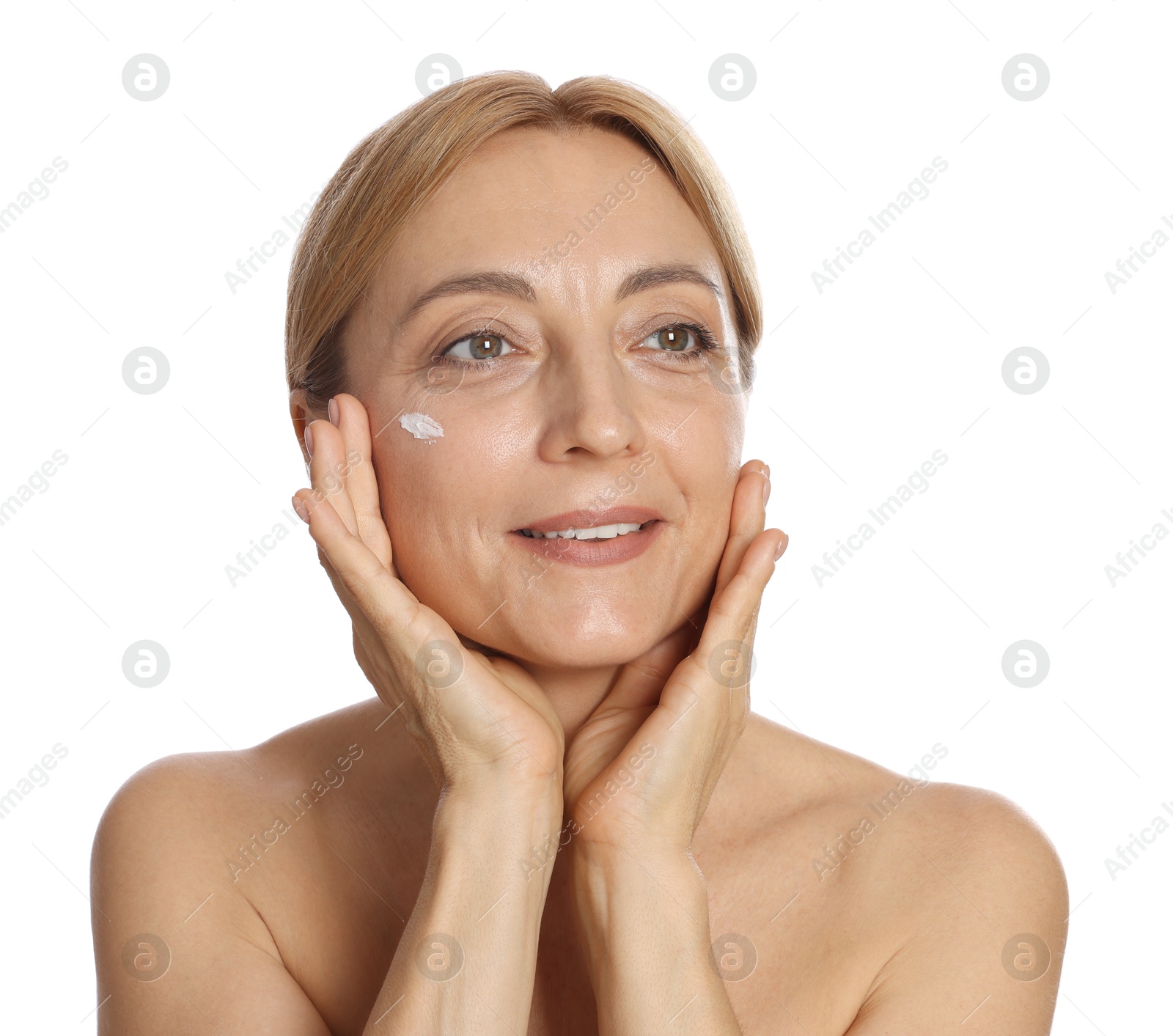 Photo of Smiling woman with cream on face against white background