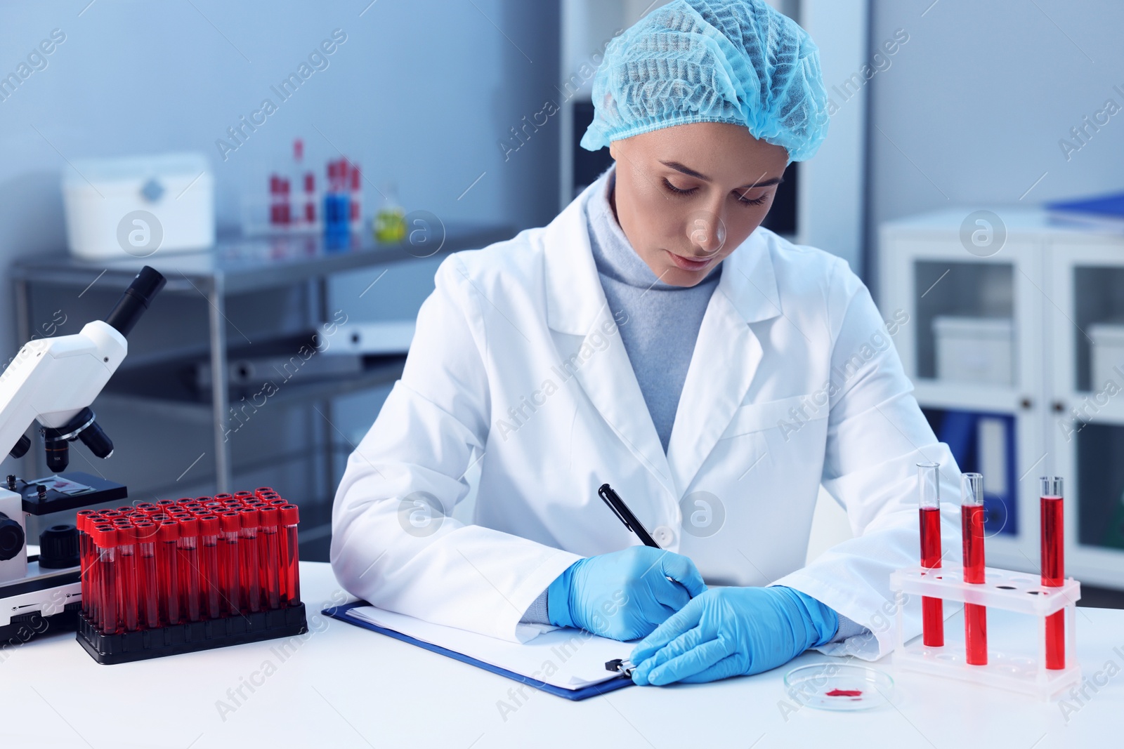 Photo of Laboratory testing. Doctor working at white table indoors