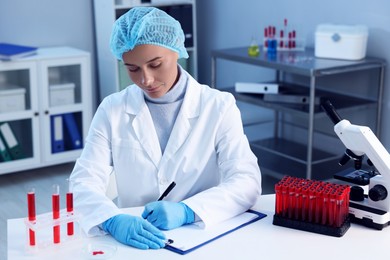 Laboratory testing. Doctor working at white table indoors