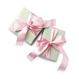 Photo of Beautiful gift boxes with pink bows isolated on white, top view