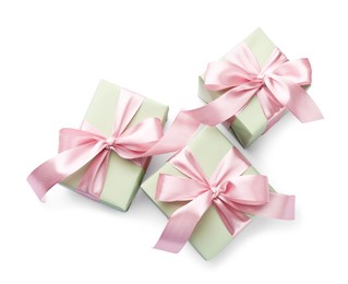 Photo of Beautiful gift boxes with pink bows isolated on white, top view