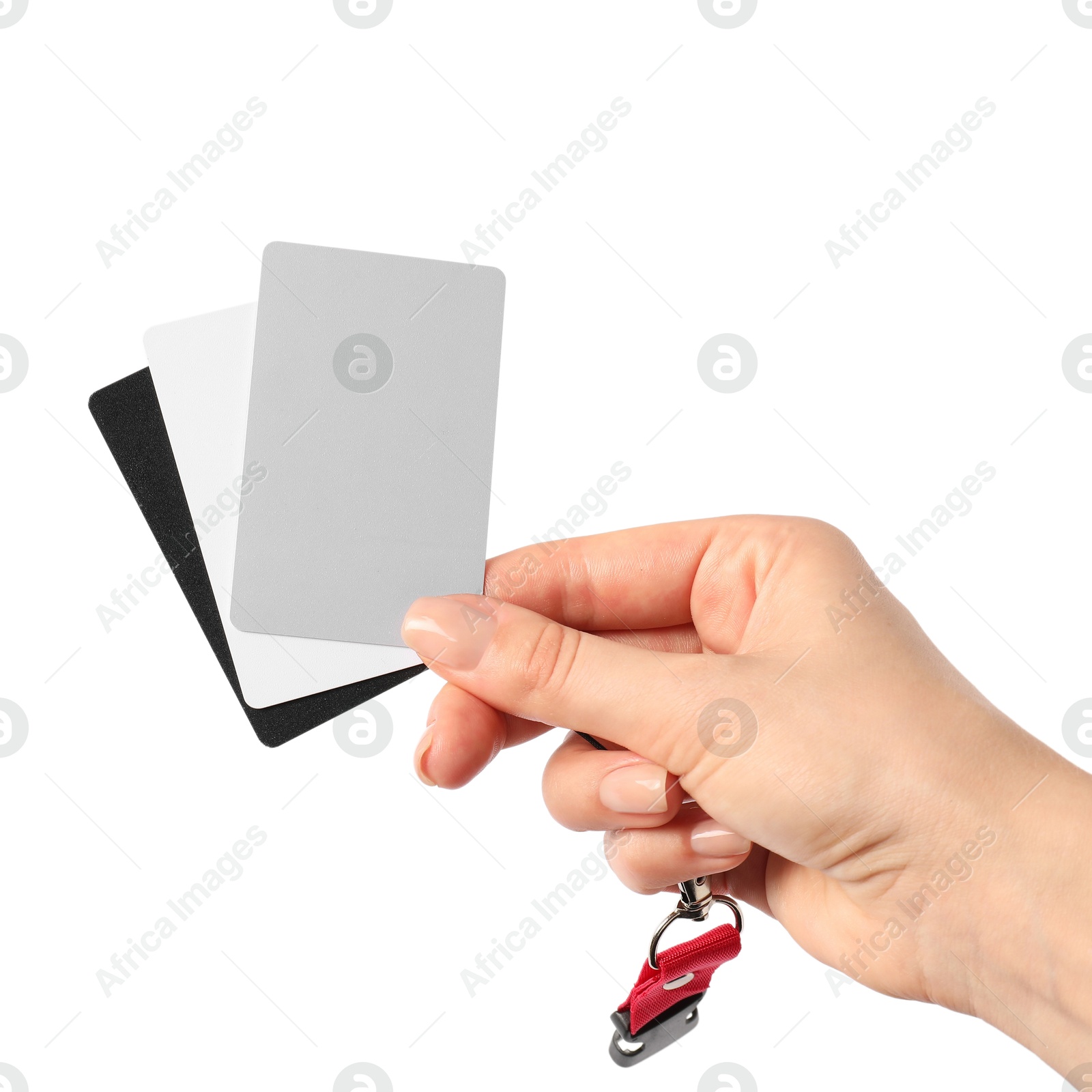 Photo of Woman with white balance calibration cards on white background, closeup