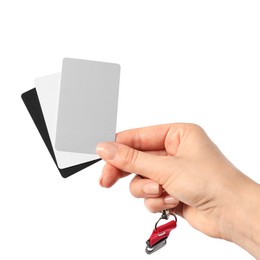 Photo of Woman with white balance calibration cards on white background, closeup