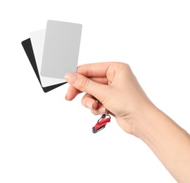 Photo of Woman with white balance calibration cards on white background, closeup