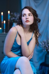 Photo of Beautiful young woman sitting in room. Fashion vintage style portrait